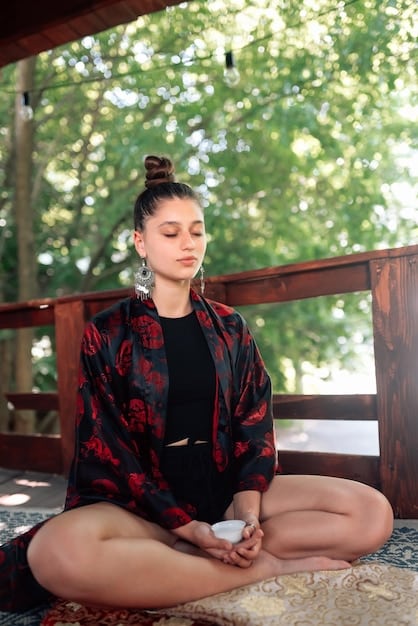 A motivational photo of Olivia Davis meditating or doing mindfulness exercises in a quiet, natural setting. Her expression is serene and focused, representing her mental and emotional preparation. Soft, natural lighting enhances the sense of calm and determination.